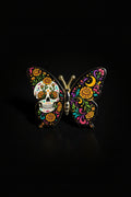 Black butterfly pin with Day of the Dead sugar skull and marigold florals