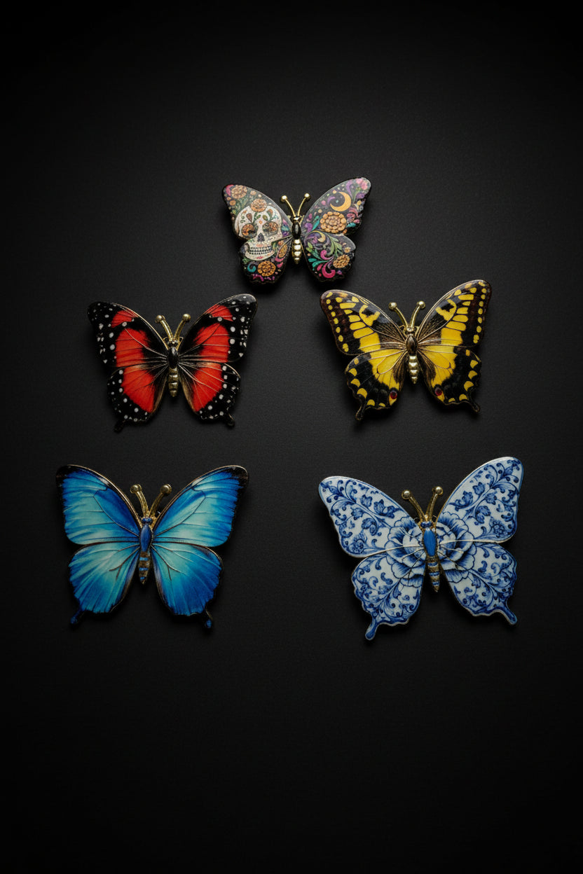 All five Becoming Collection Luminous Series butterfly pins on white fur